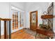 Inviting foyer with hardwood floors and detailed glass front door at 7674 Bermuda Hills Ln, Denver, NC 28037
