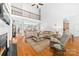 Open-concept living room with hardwood floors, soaring ceilings, and balcony overlooking the space below at 7674 Bermuda Hills Ln, Denver, NC 28037