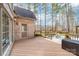 Large wooden deck overlooking backyard with an additional outdoor entertainment space at 7674 Bermuda Hills Ln, Denver, NC 28037