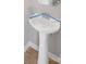 Bathroom featuring a white pedestal sink and chrome faucet, simple and functional at 8007 Shadbrush Ct, Charlotte, NC 28215