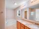 Bright bathroom featuring double sink vanity, large mirror, and separate tub and shower at 8007 Shadbrush Ct, Charlotte, NC 28215