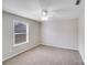 Bright, neutral bedroom with carpeted floor, ceiling fan, and natural light from the window at 8007 Shadbrush Ct, Charlotte, NC 28215