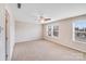 Bright, carpeted bedroom with ceiling fan and large windows offering ample natural light at 8007 Shadbrush Ct, Charlotte, NC 28215