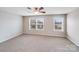 Bedroom featuring neutral paint, carpeted floor, and natural light from the two windows at 8007 Shadbrush Ct, Charlotte, NC 28215