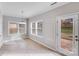 Sunny breakfast nook with tile flooring, multiple windows, and access to the patio at 8007 Shadbrush Ct, Charlotte, NC 28215