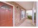 Charming front porch featuring stone accents, and a stylish front door at 8007 Shadbrush Ct, Charlotte, NC 28215