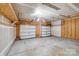 Two car garage with overhead lighting, exposed rafters, and unfinished walls at 8007 Shadbrush Ct, Charlotte, NC 28215