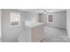 Upstairs hallway with neutral paint, carpeted floor, and natural light from the windows at 8007 Shadbrush Ct, Charlotte, NC 28215
