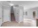 Hallway with view to staircase, back yard door and an open view to the kitchen at 8007 Shadbrush Ct, Charlotte, NC 28215