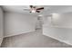Upstairs hallway featuring neutral paint, carpeted floor, and ceiling fan with lighting at 8007 Shadbrush Ct, Charlotte, NC 28215