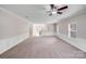 Expansive living room with carpet, neutral walls, and an open flow to the kitchen area at 8007 Shadbrush Ct, Charlotte, NC 28215