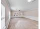 Bright and spacious living room featuring neutral carpet, wainscoting, and large windows at 8007 Shadbrush Ct, Charlotte, NC 28215