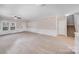 Open living room with carpet, neutral walls, view to stairway, and front door entry at 8007 Shadbrush Ct, Charlotte, NC 28215