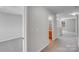 Upstairs hallway with gray carpet, neutral paint, and access to other rooms at 8007 Shadbrush Ct, Charlotte, NC 28215