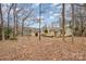 Spacious backyard featuring trees, grass and a deck with plenty of room to roam at 8104 Tamalpais Ct, Charlotte, NC 28215