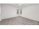 Bright, spacious bedroom with updated floors and large windows at 8104 Tamalpais Ct, Charlotte, NC 28215