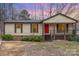 Charming single-story home features a cozy front porch and a bright red front door at 8104 Tamalpais Ct, Charlotte, NC 28215