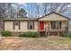 Charming single-story home features a cozy front porch and a bright red front door at 8104 Tamalpais Ct, Charlotte, NC 28215