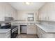 Well-lit kitchen equipped with stainless steel appliances and marble-look countertops at 8104 Tamalpais Ct, Charlotte, NC 28215
