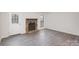 Comfortable living room features stone fireplace and access to the backyard at 8104 Tamalpais Ct, Charlotte, NC 28215