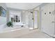 Bright bathroom boasts a jacuzzi tub beneath a window and a separate shower with a gold frame at 907 Thorn Ridge Ln, Lake Wylie, SC 29710