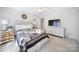 Well-lit bedroom featuring a TV, ceiling fan, and a large window at 907 Thorn Ridge Ln, Lake Wylie, SC 29710