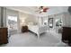 Spacious bedroom featuring tray ceiling, natural light from windows, and a four-poster bed at 907 Thorn Ridge Ln, Lake Wylie, SC 29710