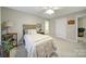 Comfortable bedroom with a lamp on a side table, offering a view to the bathroom at 907 Thorn Ridge Ln, Lake Wylie, SC 29710