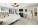 Bedroom featuring a tray ceiling, and television above a dark wood dresser at 907 Thorn Ridge Ln, Lake Wylie, SC 29710