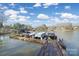 A wooden dock featuring multiple boats and boat lifts on a lake at 907 Thorn Ridge Ln, Lake Wylie, SC 29710