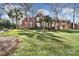 A lush front yard with a beautiful brick home and manicured landscaping at 907 Thorn Ridge Ln, Lake Wylie, SC 29710