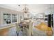 Bright dining area near the open kitchen with white cabinetry and hardwood floors at 907 Thorn Ridge Ln, Lake Wylie, SC 29710