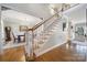 Elegant staircase with carpeted treads, white risers, and wood railing adds character to the entry at 907 Thorn Ridge Ln, Lake Wylie, SC 29710