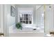 Lovely bathroom with a white tub, window, white tiles and glass shower at 907 Thorn Ridge Ln, Lake Wylie, SC 29710