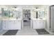Bright bathroom featuring double vanities and mirrors, with an open doorway to the Primary bedroom at 907 Thorn Ridge Ln, Lake Wylie, SC 29710