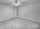Bedroom with neutral walls, carpet flooring, ceiling fan, and open door at 907 Thorn Ridge Ln, Lake Wylie, SC 29710