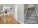 Inviting entryway showcasing hardwood floors, stairs, and an open view of the modern kitchen and spacious layout at 907 Thorn Ridge Ln, Lake Wylie, SC 29710