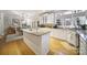 Bright eat-in kitchen featuring granite countertops, white cabinetry, stainless appliances, and a hardwood floor at 907 Thorn Ridge Ln, Lake Wylie, SC 29710