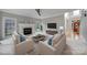 Well-lit living room showcases a modern fireplace, TV, comfortable seating, and large windows, offering a bright and inviting space at 907 Thorn Ridge Ln, Lake Wylie, SC 29710