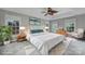 Beautiful staged main bedroom featuring neutral walls, tray ceiling, leafy ceiling fan, and big windows for lots of light at 907 Thorn Ridge Ln, Lake Wylie, SC 29710
