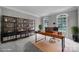 Office featuring a large desk, bookshelves, and natural light from the two symmetrically placed windows at 907 Thorn Ridge Ln, Lake Wylie, SC 29710