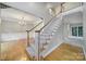 Staircase with carpeted steps, wooden railing, and white spindles with view to dining room at 907 Thorn Ridge Ln, Lake Wylie, SC 29710