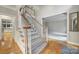 Staircase featuring carpeted steps, wooden banister, and white spindles, with a glimpse into adjacent rooms at 907 Thorn Ridge Ln, Lake Wylie, SC 29710