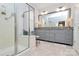 Elegant bathroom featuring a glass-enclosed shower and a spacious double vanity with granite countertops at 9119 Gander Dr, Charlotte, NC 28277