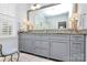 Spacious bathroom featuring a large vanity with granite countertops, double sinks, and a view of the glass enclosed shower at 9119 Gander Dr, Charlotte, NC 28277