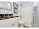 Bathroom features a vanity with granite countertop, framed mirror and tub with shower at 9119 Gander Dr, Charlotte, NC 28277