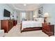 Comfortable bedroom featuring tray ceilings, soft natural light from the window, and classic wood furnishings at 9119 Gander Dr, Charlotte, NC 28277