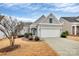 Charming home featuring a two-car garage, stone accents, and a beautifully landscaped front yard at 9119 Gander Dr, Charlotte, NC 28277