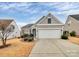 Charming home featuring a two-car garage, stone accents, and a beautifully landscaped front yard at 9119 Gander Dr, Charlotte, NC 28277