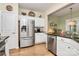 Kitchen featuring stainless steel refrigerator, white cabinets, and a view to the breakfast nook at 9119 Gander Dr, Charlotte, NC 28277